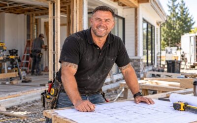 Builder reviewing construction drawings on a renovation job site